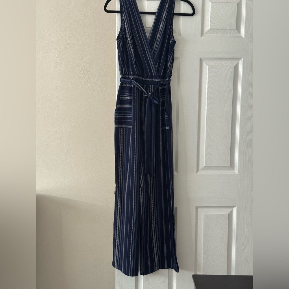 Navy and white wide leg jumpsuit. V front and back. Pockets, tie waist.
